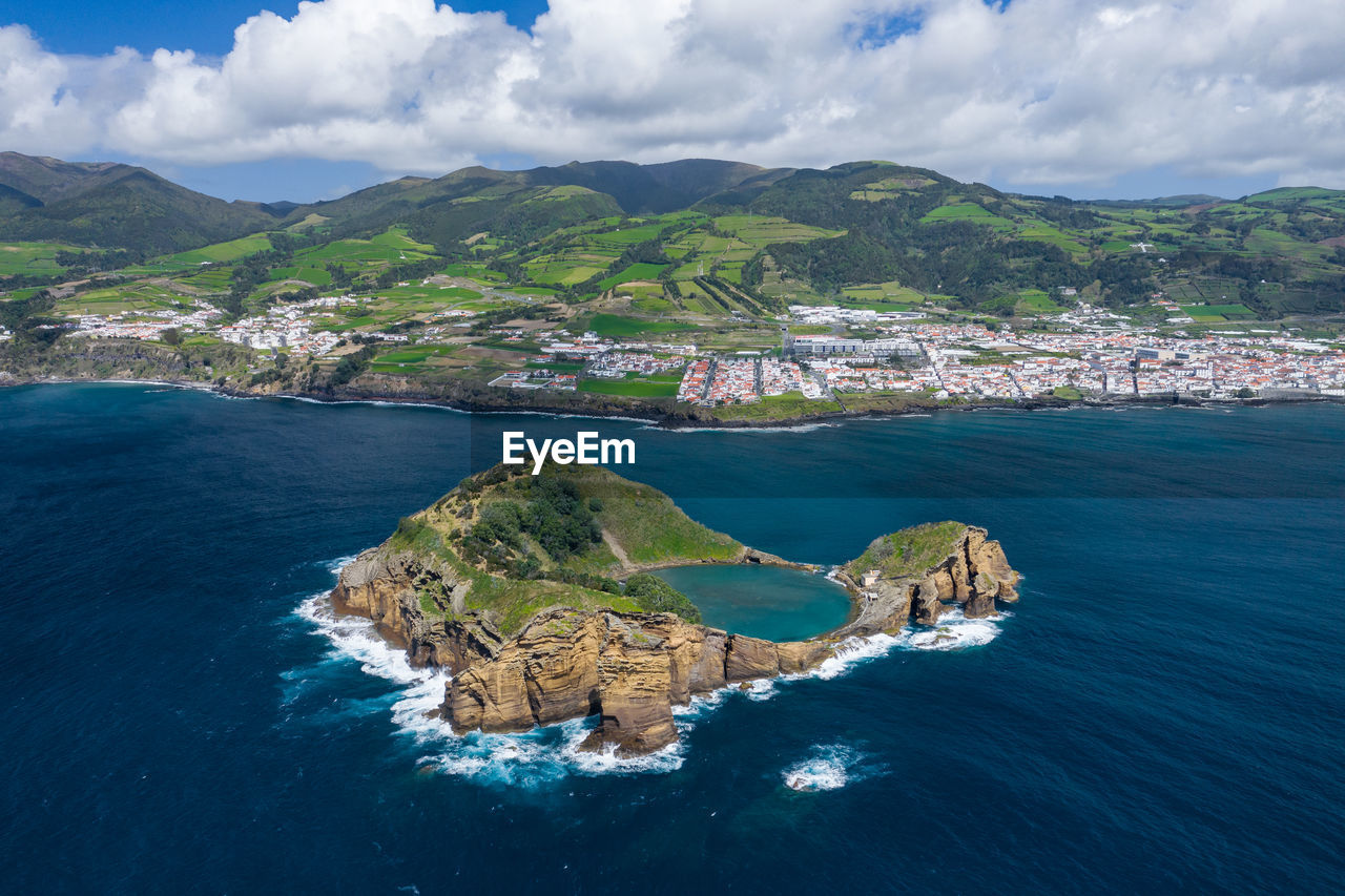 Scenic view of sea and buildings against sky