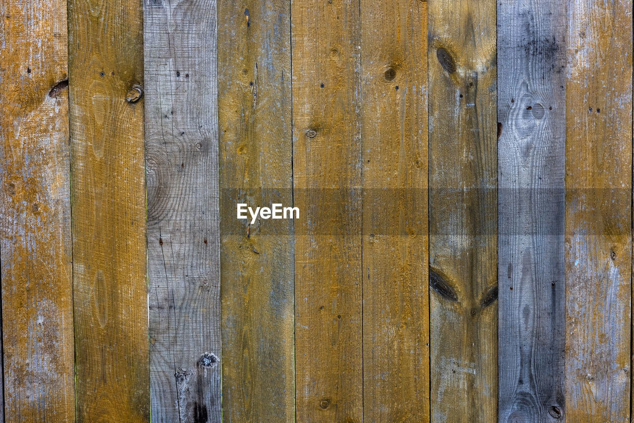 Old dry weathered gray and brown wooden planks board surface - full frame background and texture