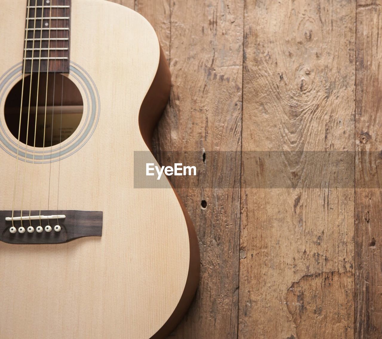 Close-up of guitar on wooden table