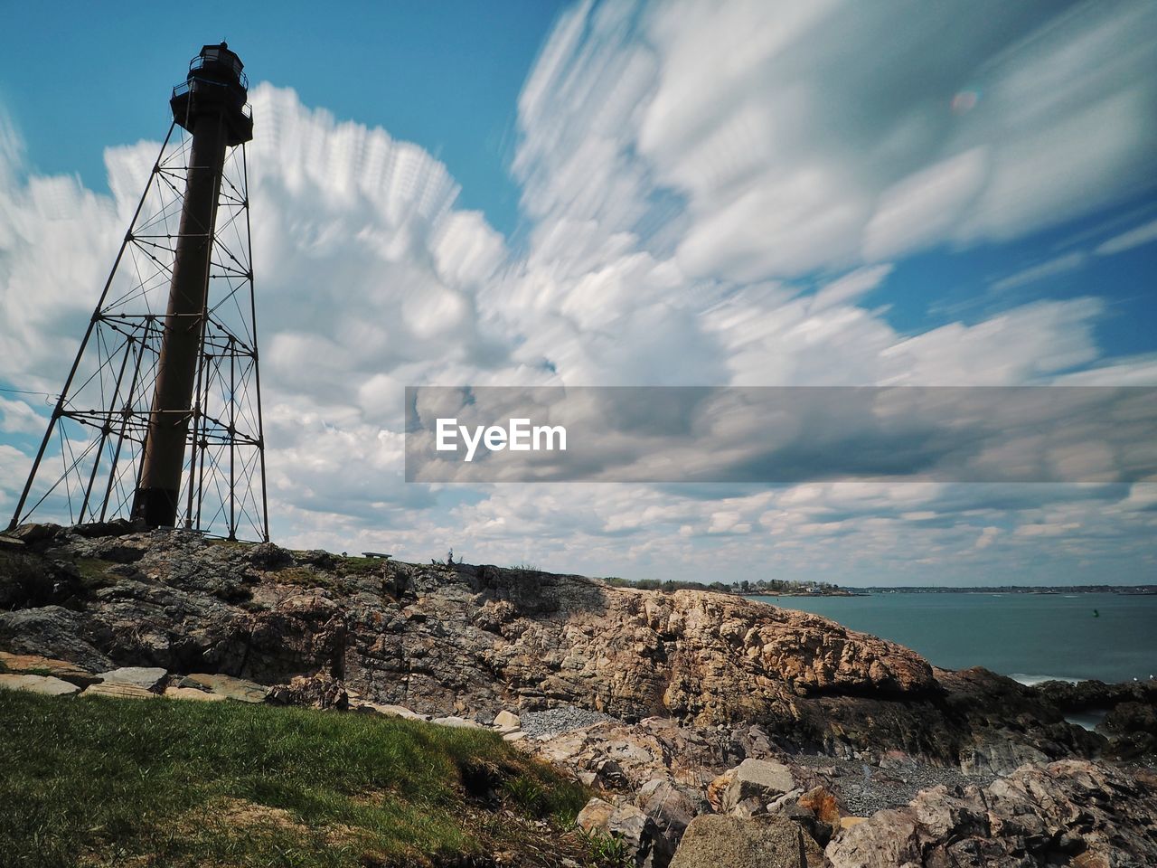 LIGHTHOUSE ON LAND AGAINST SKY