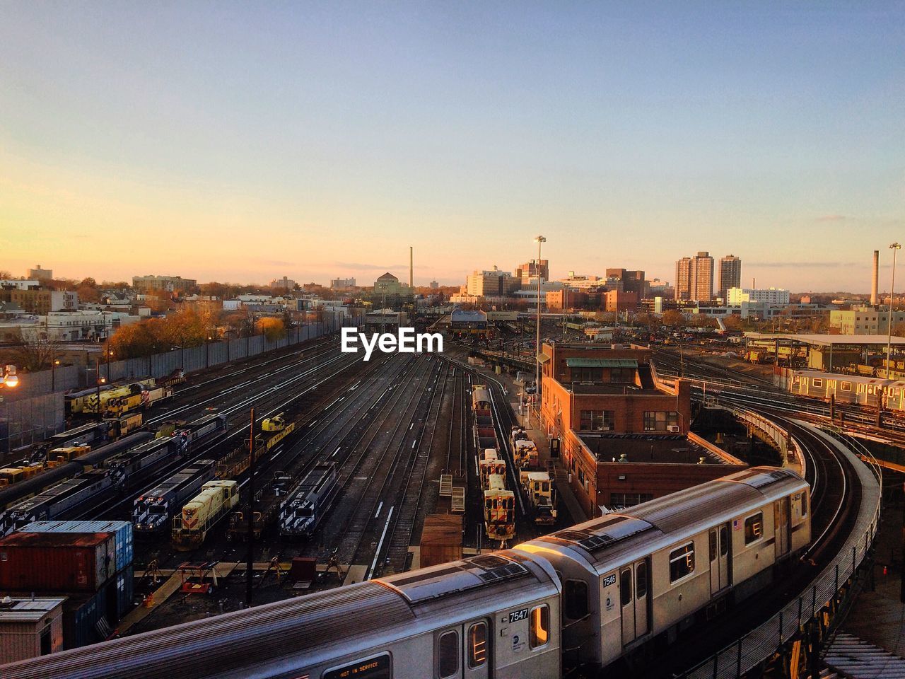 High angle view of trains at shunting yard against sky in city