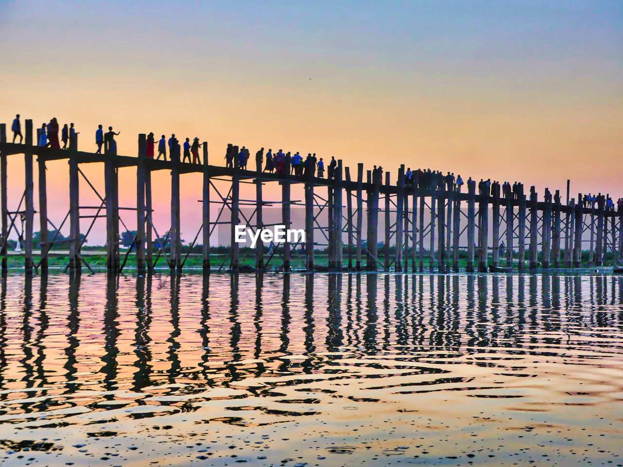 Pier on sea against sky during sunset