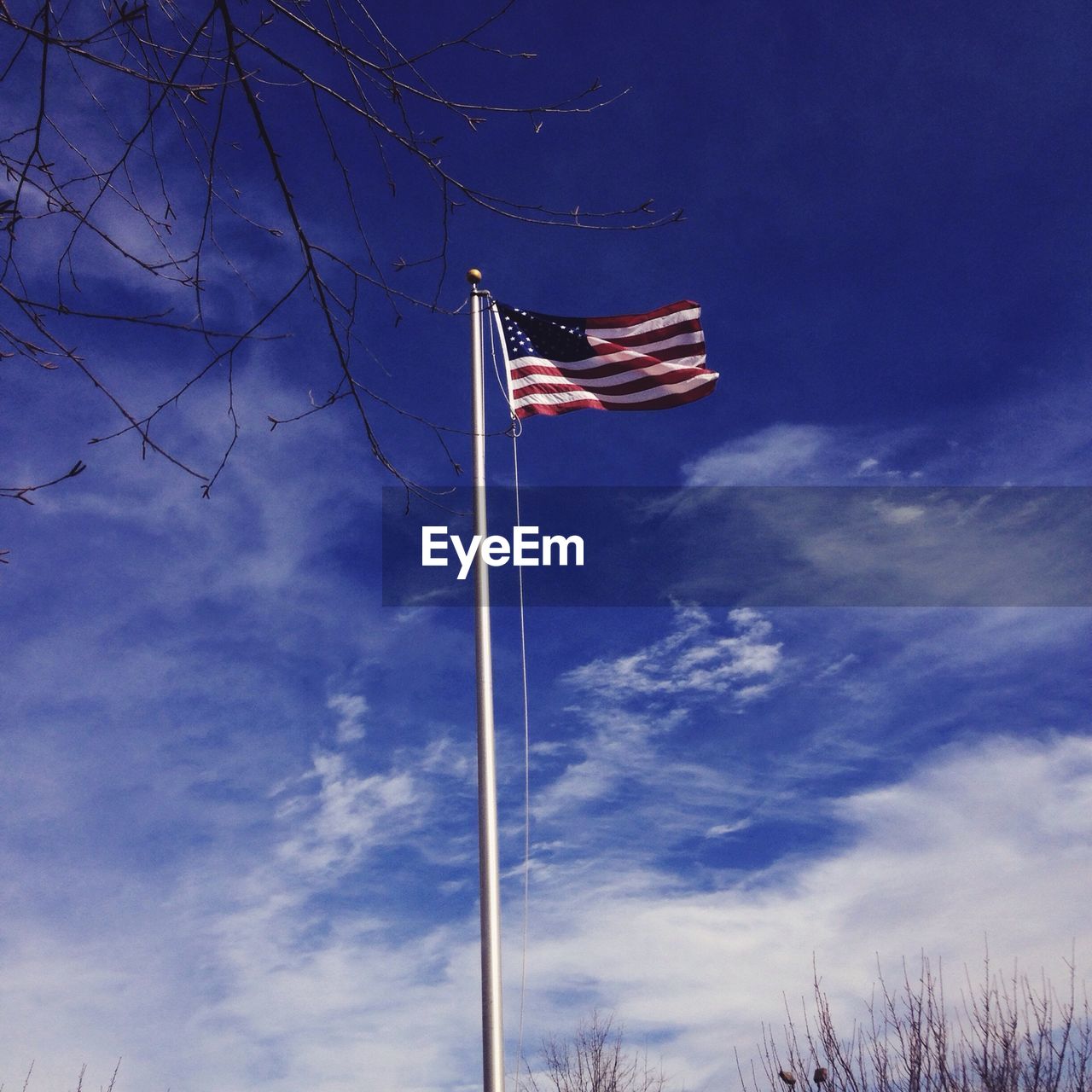 LOW ANGLE VIEW OF POLES AGAINST BLUE SKY