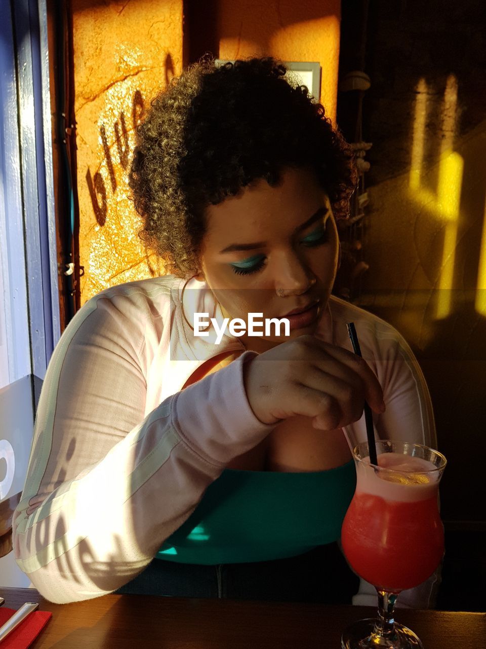 YOUNG WOMAN DRINKING GLASS AT HOME