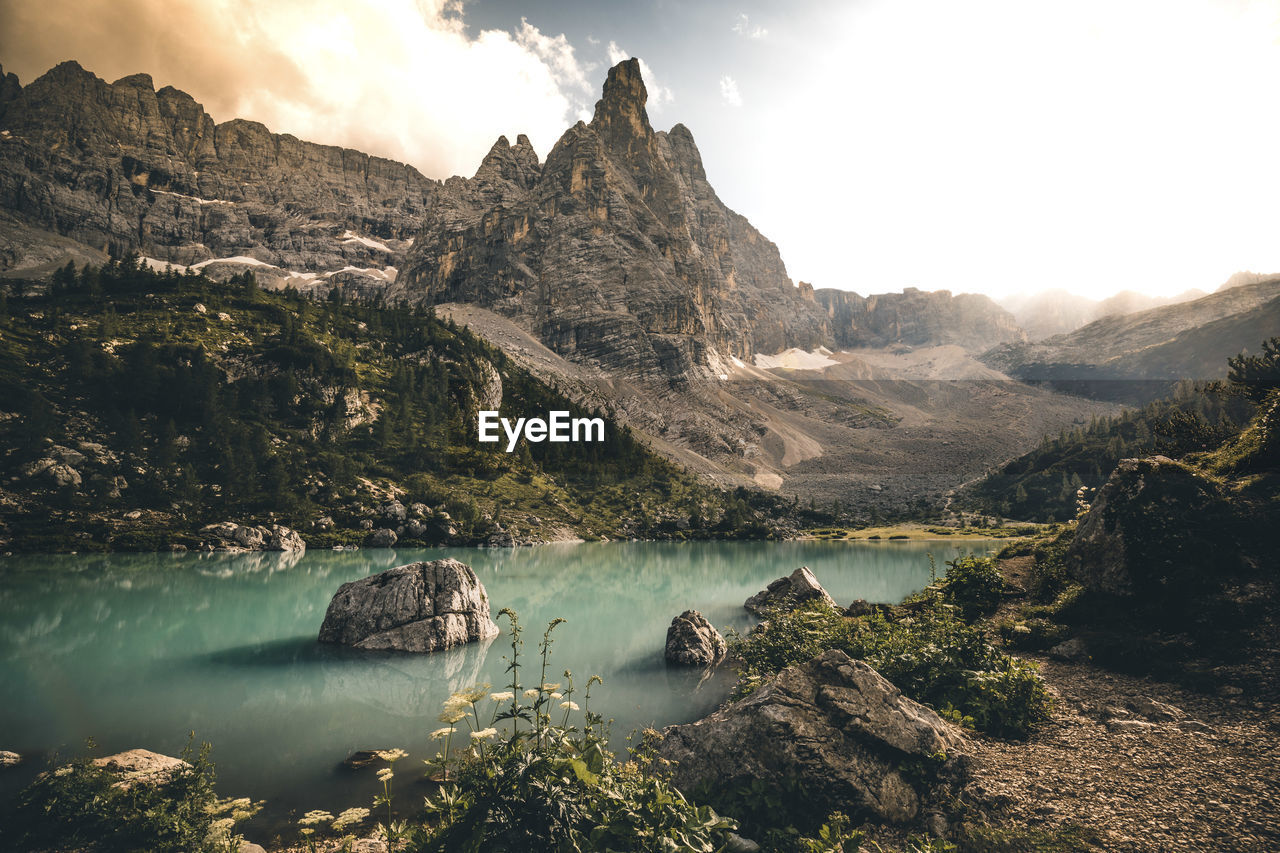 Scenic view of lake and mountains against sky