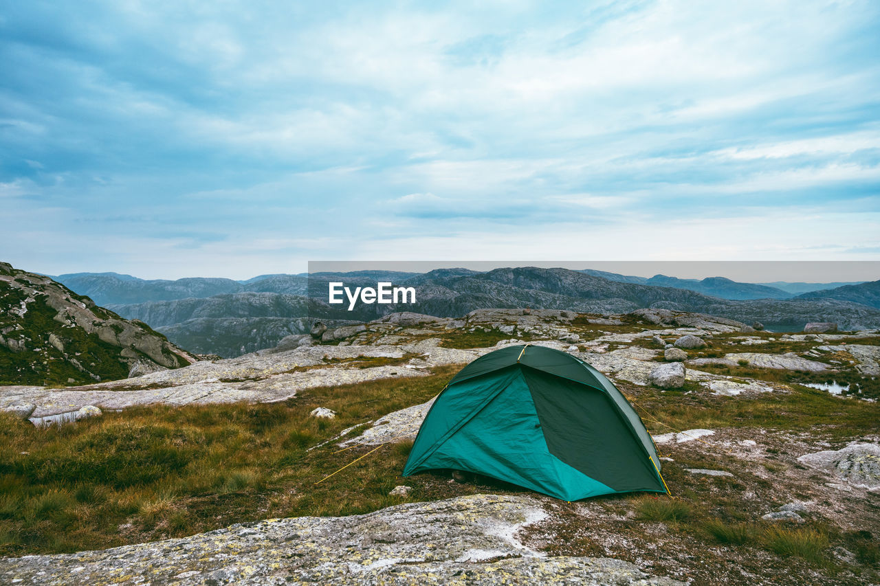 Scenic view of tent on mountain against sky