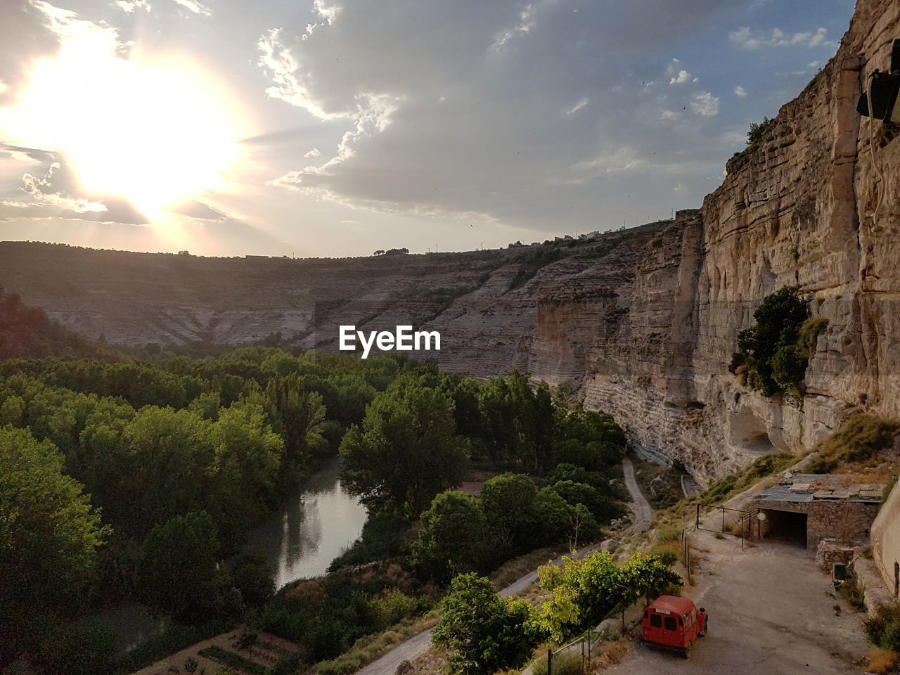 Scenic view of trees amidst rock formations against sky