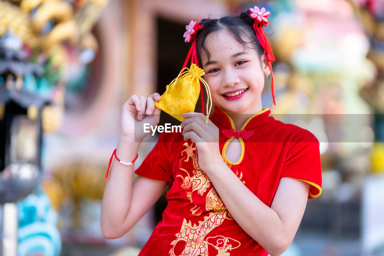 Portrait of smiling girl holding bag