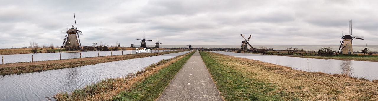 PANORAMIC VIEW OF ROAD AMIDST BUILDINGS AGAINST SKY