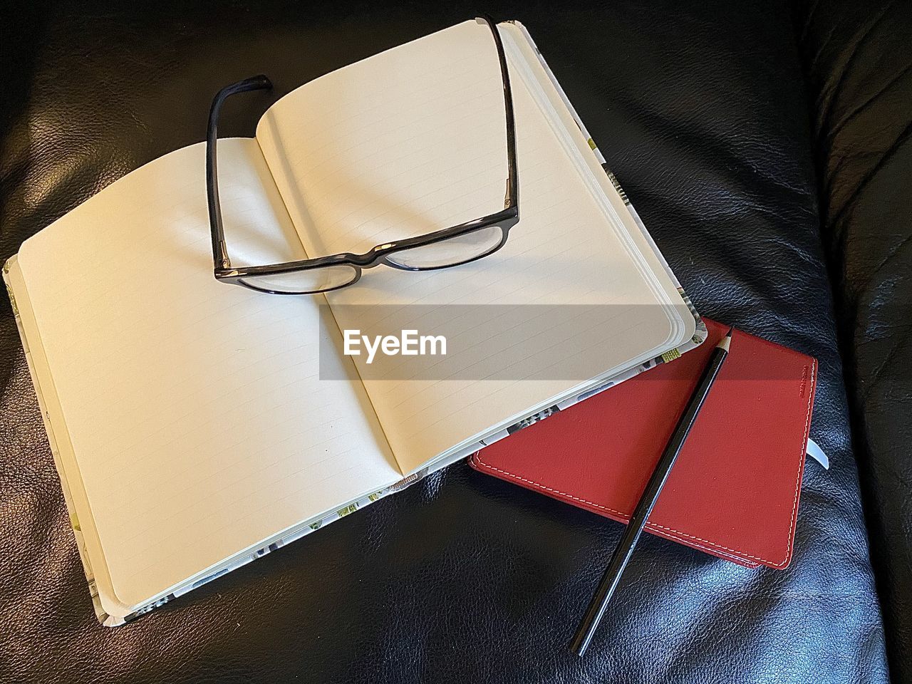 indoors, no people, glasses, eyeglasses, high angle view, table, brown, still life, paper, leather, furniture, fashion accessory, publication, book, close-up