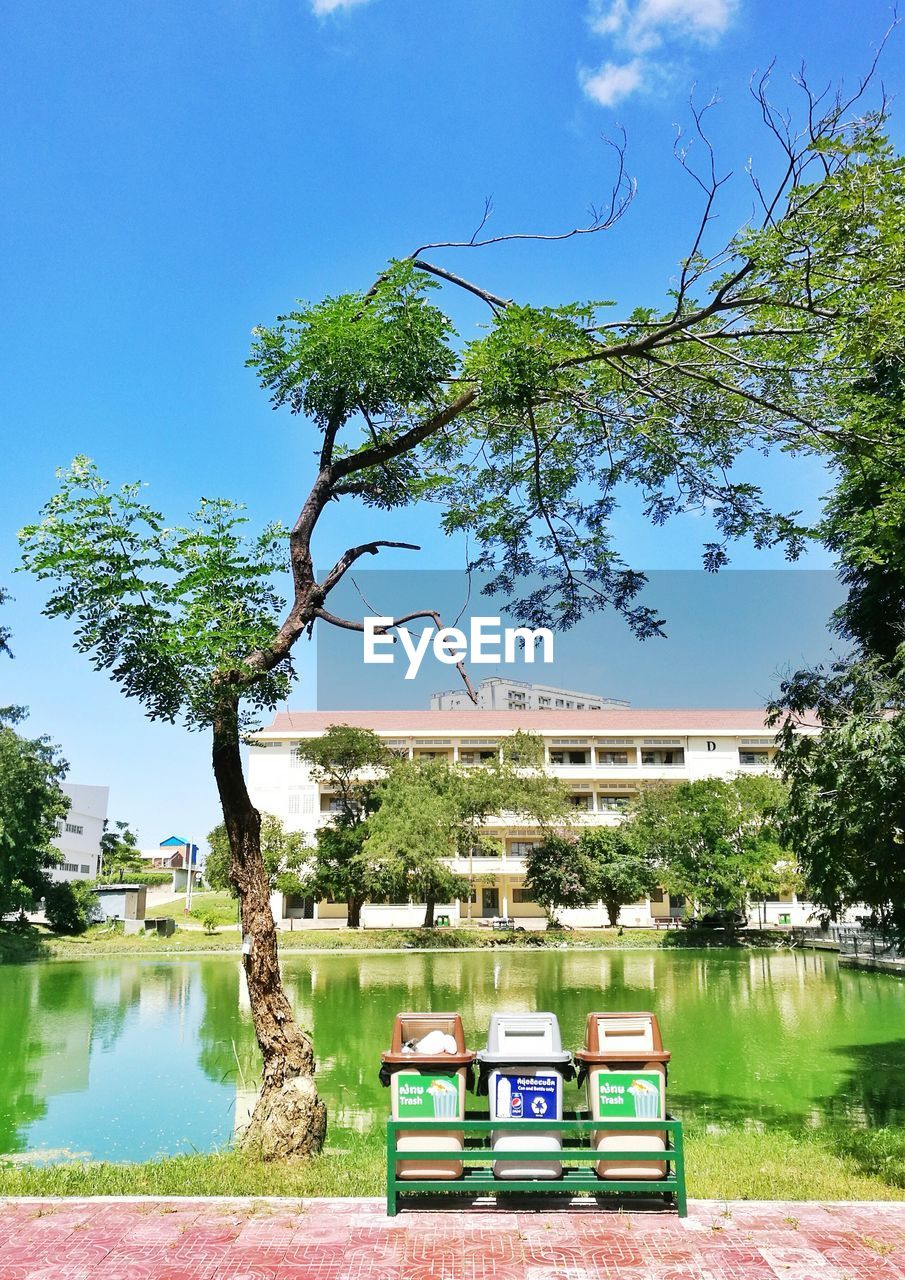 PARK BY LAKE AGAINST CLEAR BLUE SKY