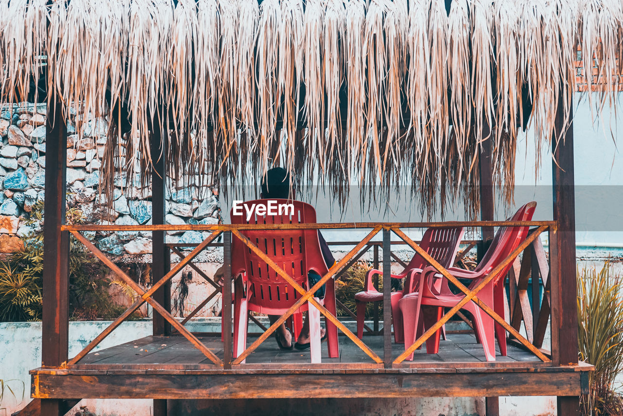 Man resting under the hut
