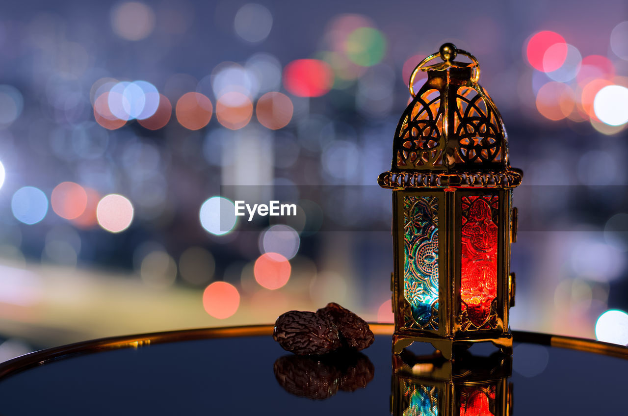 Lantern and dates fruit with night sky for the muslim feast of the holy month of ramadan kareem.