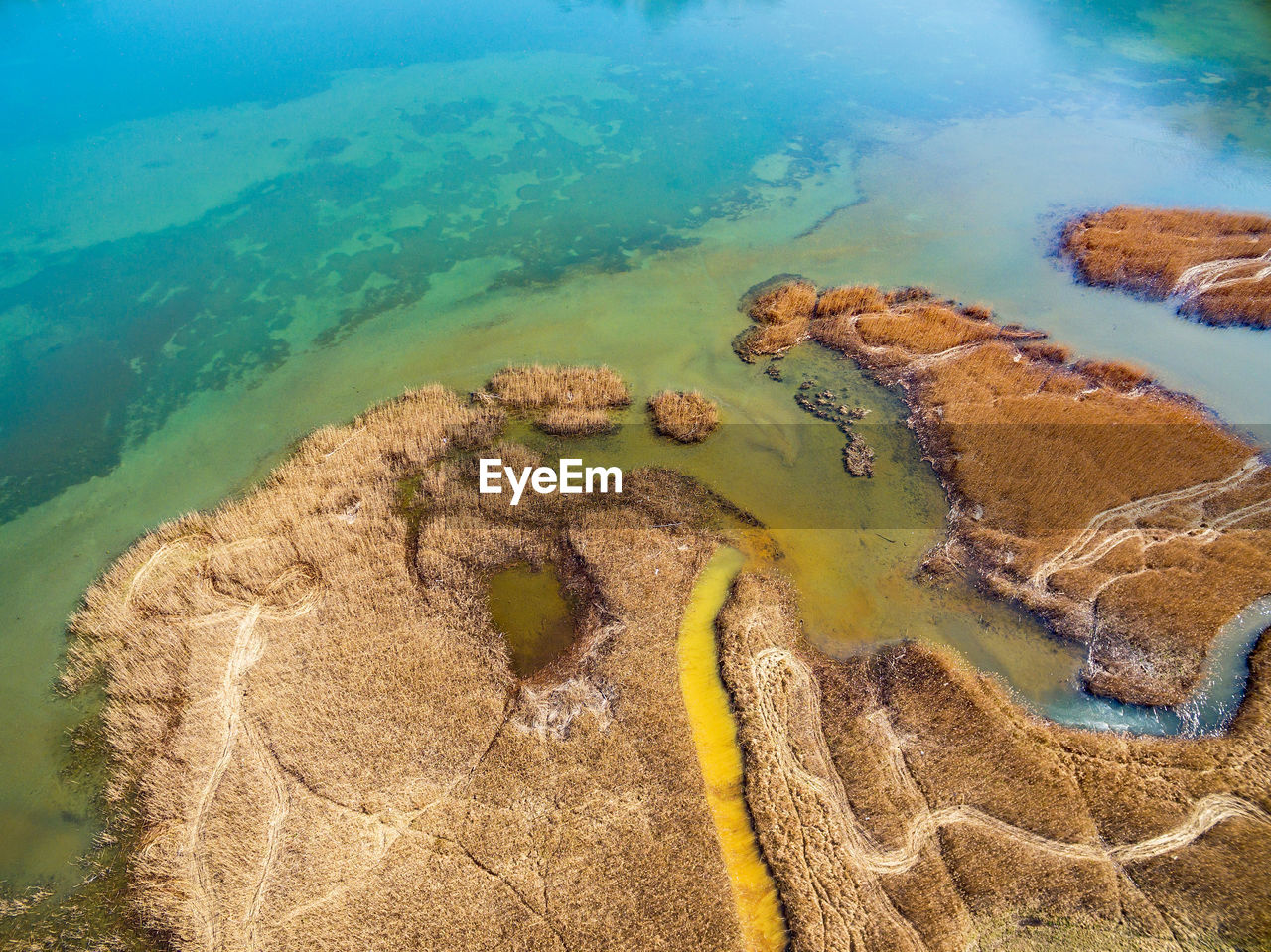 HIGH ANGLE VIEW OF ROCKS ON SHORE AT BEACH