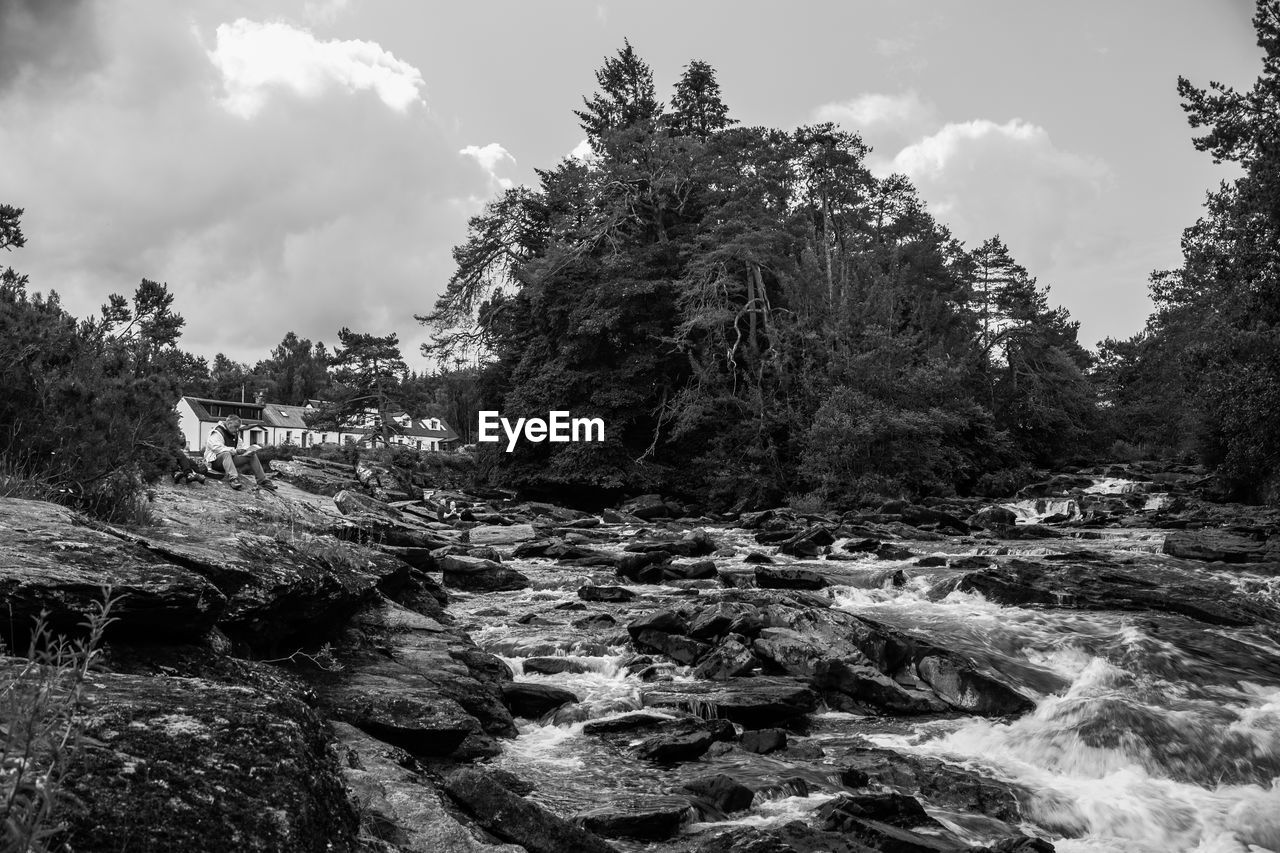 SCENIC VIEW OF STREAM AMIDST TREES AGAINST SKY