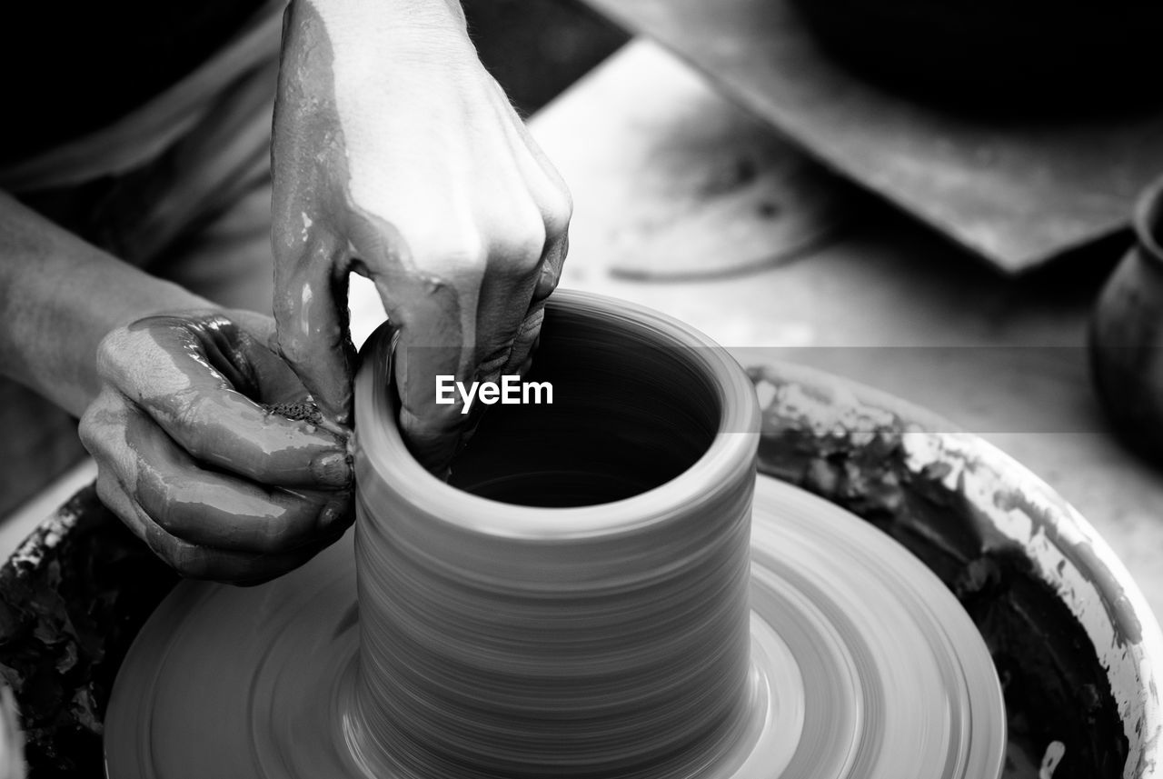 Cropped image of man making pottery