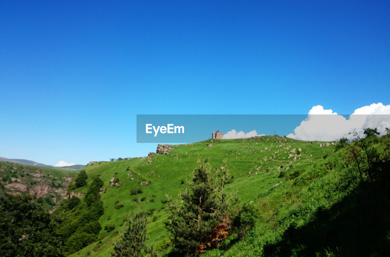 Scenic view of landscape against clear blue sky