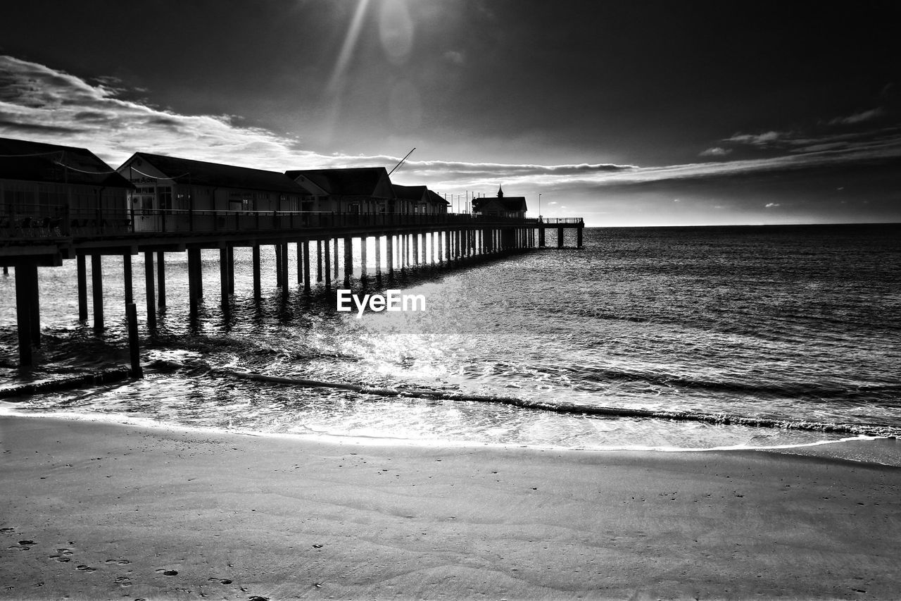 Pier in sea against sky