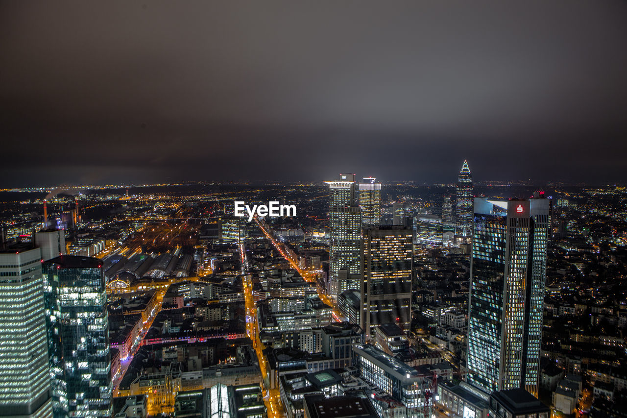 Aerial view of city lit up at night