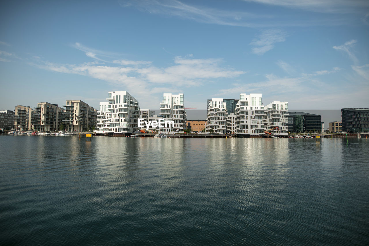 RIVER AND CITYSCAPE AGAINST SKY