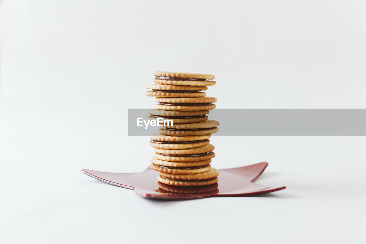 Close-up of crackers with star shape decoration against white background