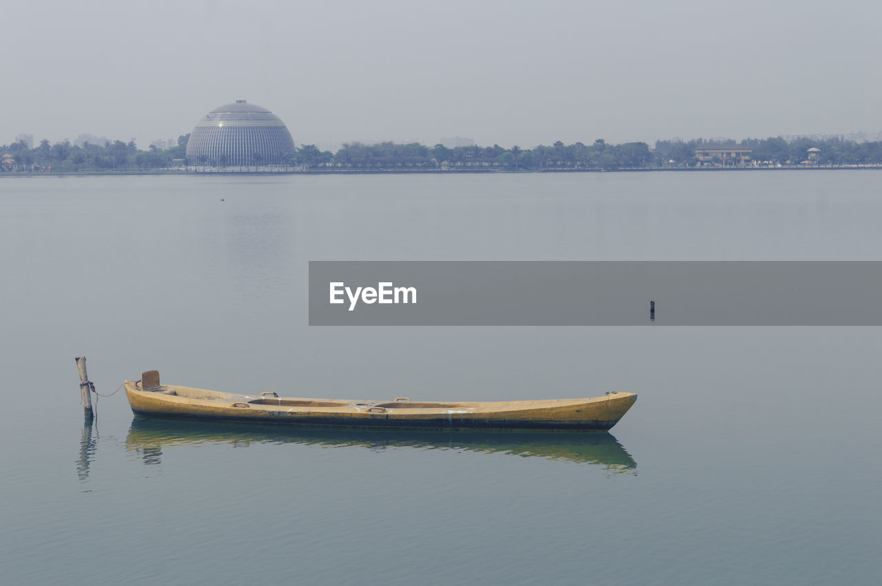 water, nautical vessel, transportation, lake, vehicle, nature, reflection, boat, architecture, mode of transportation, tranquility, sky, travel destinations, no people, travel, fog, day, outdoors, tranquil scene, built structure, boating, beauty in nature, scenics - nature, religion, building exterior, bay, watercraft, city, tourism, environment, waterfront