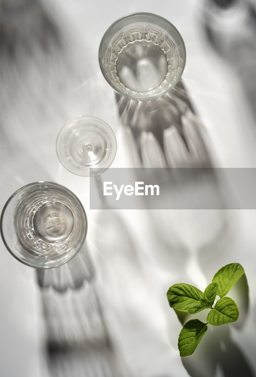 Top view of glasses on white table with mint leaves