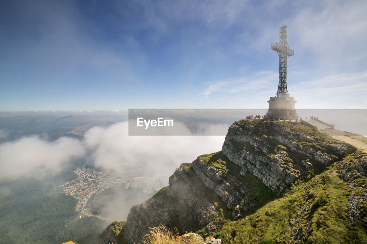 View of cross on mountain against sky