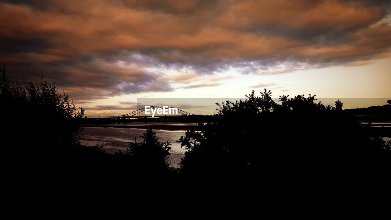 SCENIC VIEW OF DRAMATIC SKY OVER SILHOUETTE LANDSCAPE