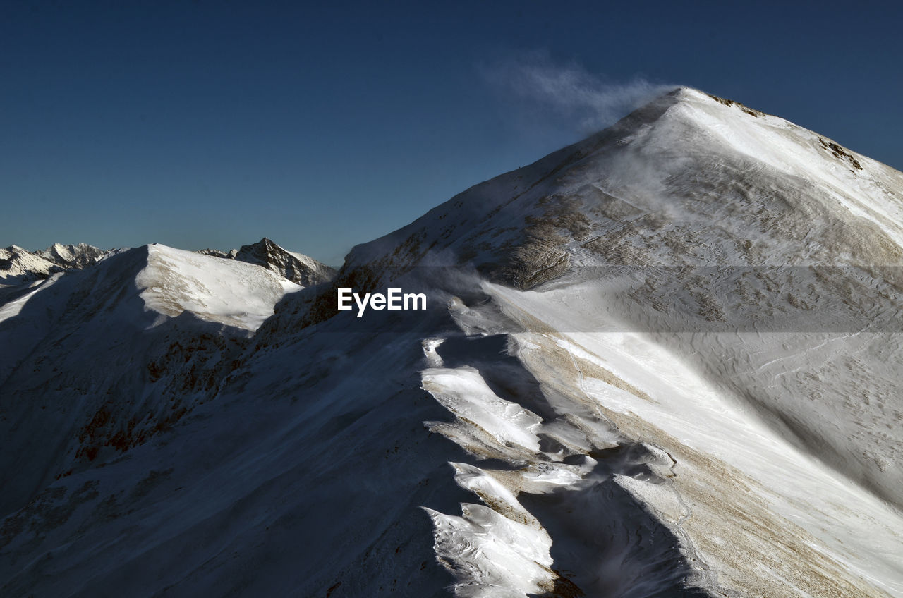 VIEW OF SNOWCAPPED MOUNTAIN AGAINST SKY