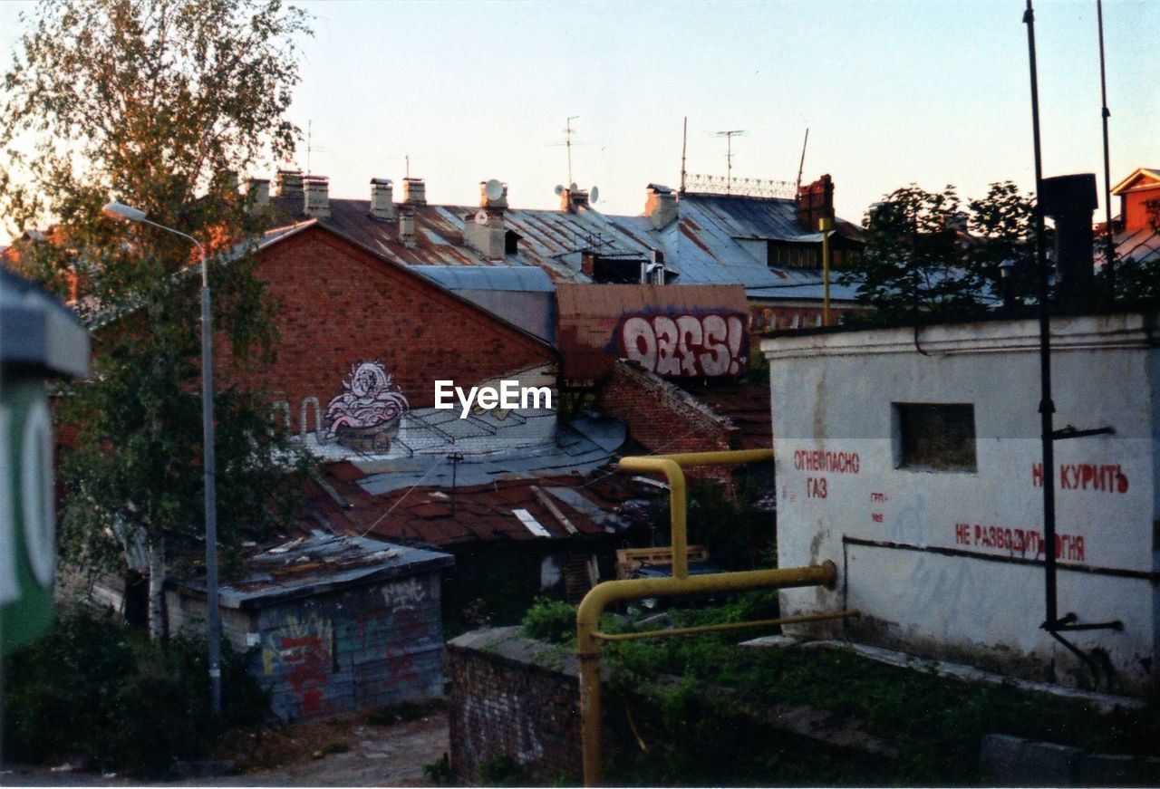 HOUSES WITH TREES IN FOREGROUND