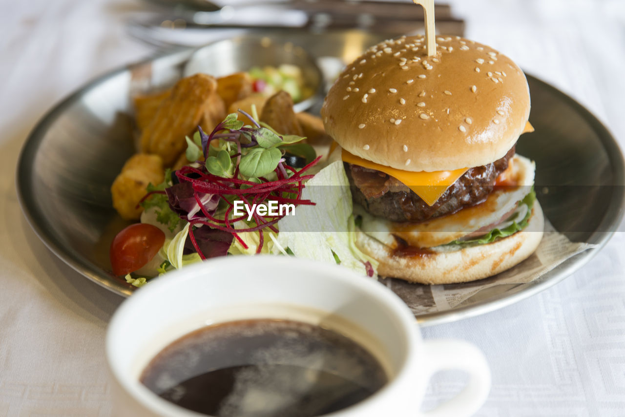 Close-up of burger with drink on table