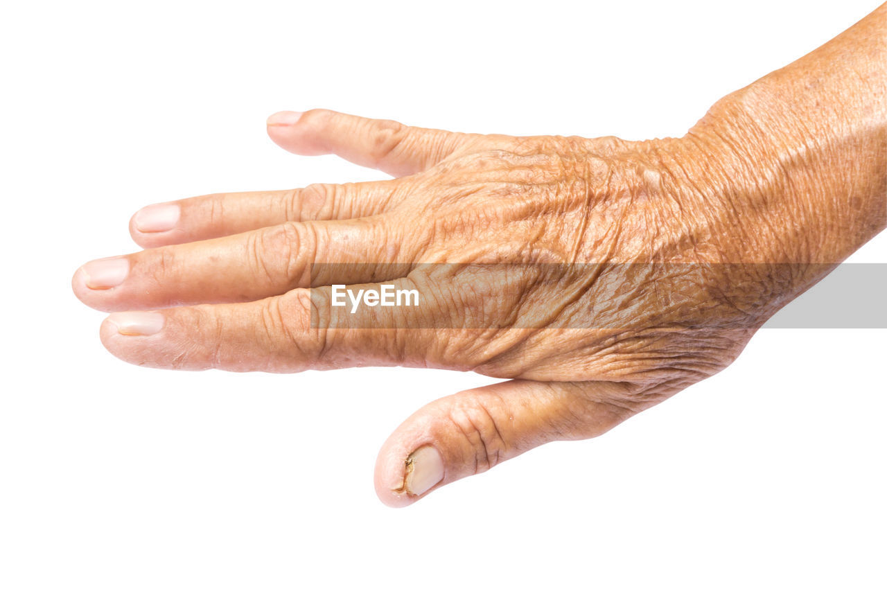 Cropped hand of senior woman over white background