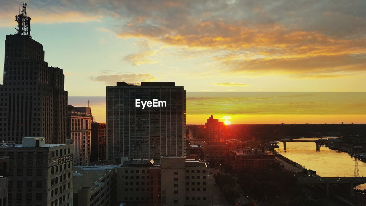 Buildings in city during sunset