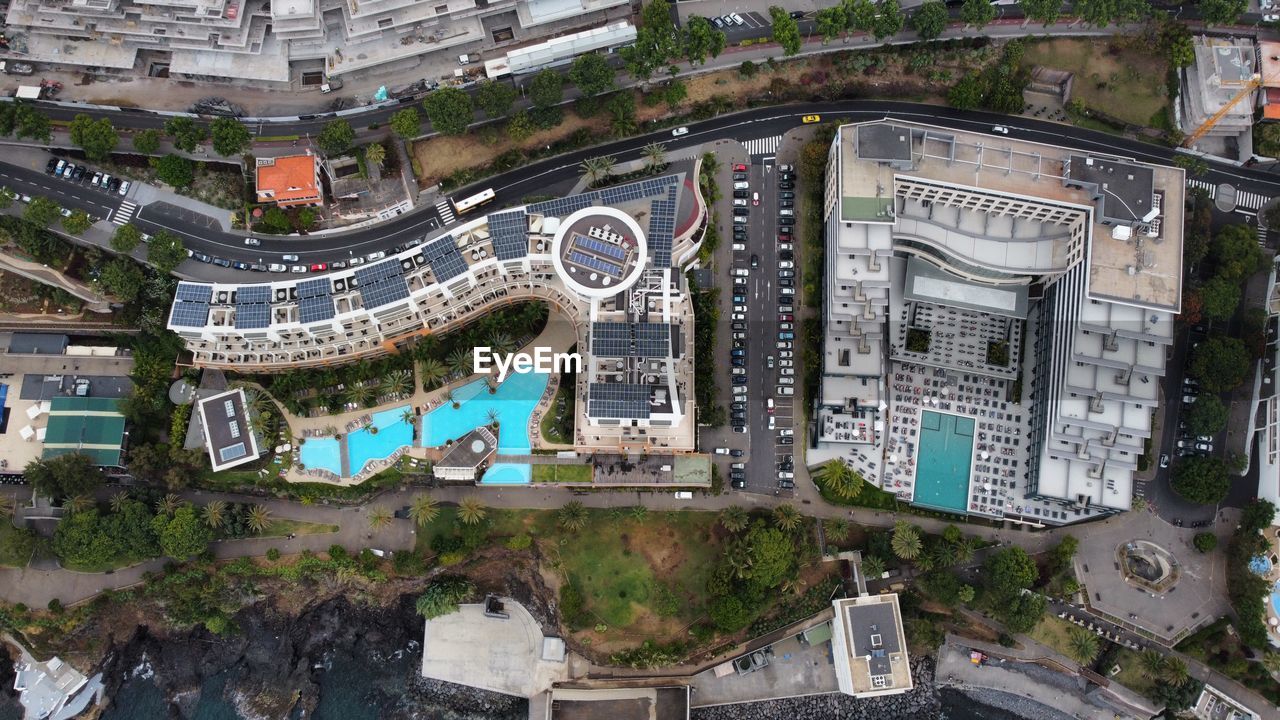architecture, bird's-eye view, aerial photography, built structure, building exterior, city, landmark, high angle view, building, neighbourhood, urban area, town, sport venue, metropolitan area, cityscape, street, aerial view, travel destinations, no people, town square, residential area, estate, nature, outdoors, road, day, transportation, travel, residential district, stadium, metropolis, history, city street, urban design, the past