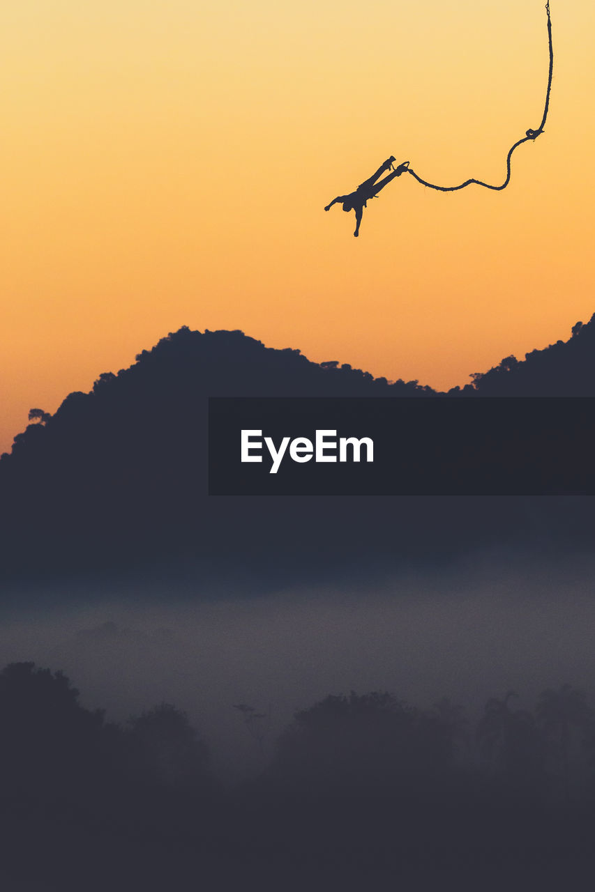 Silhouette of one person bungee jumping