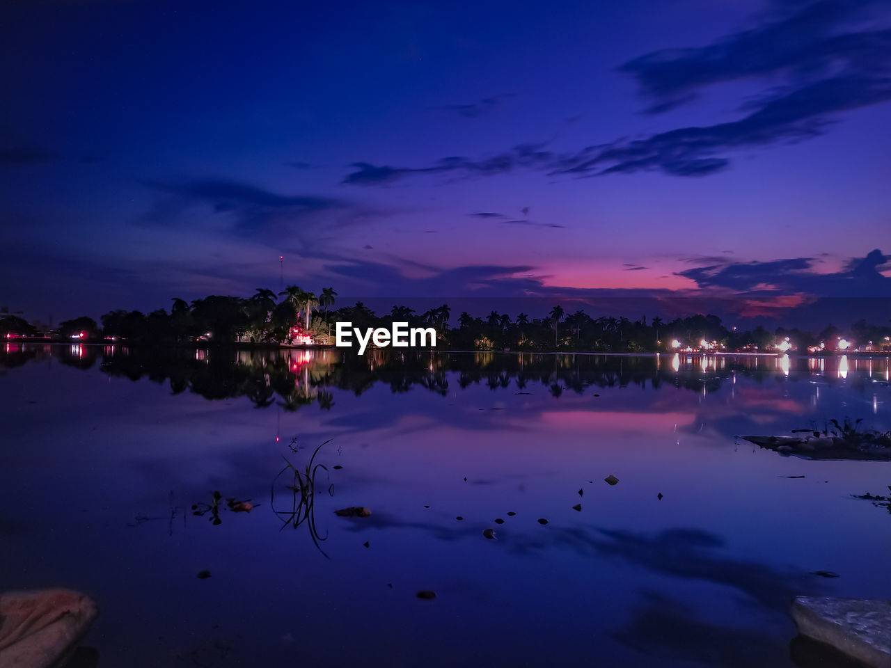 Scenic view of lake against sky at night