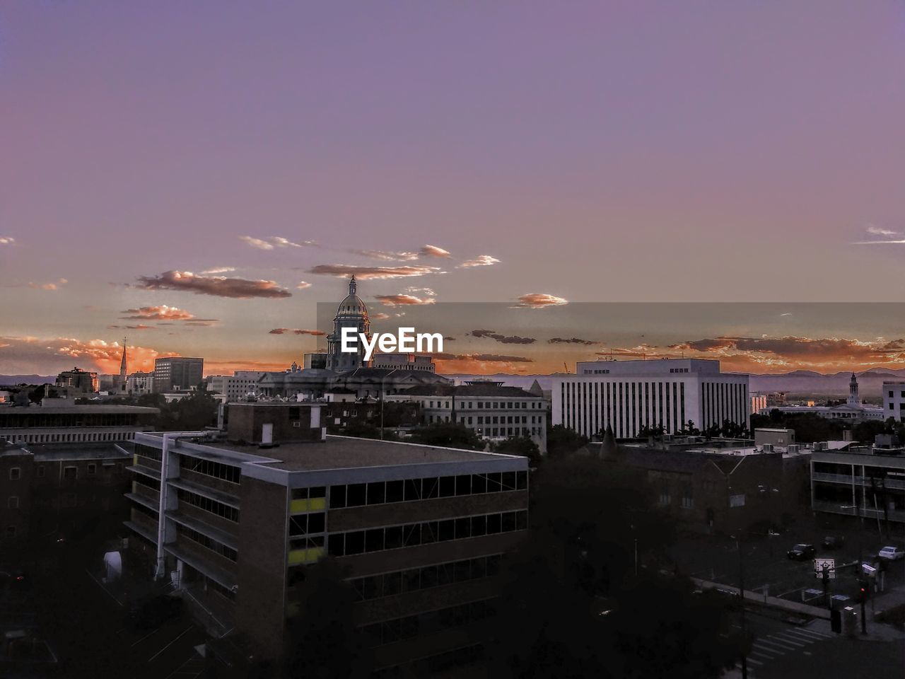 High angle view of illuminated buildings against sky during sunset