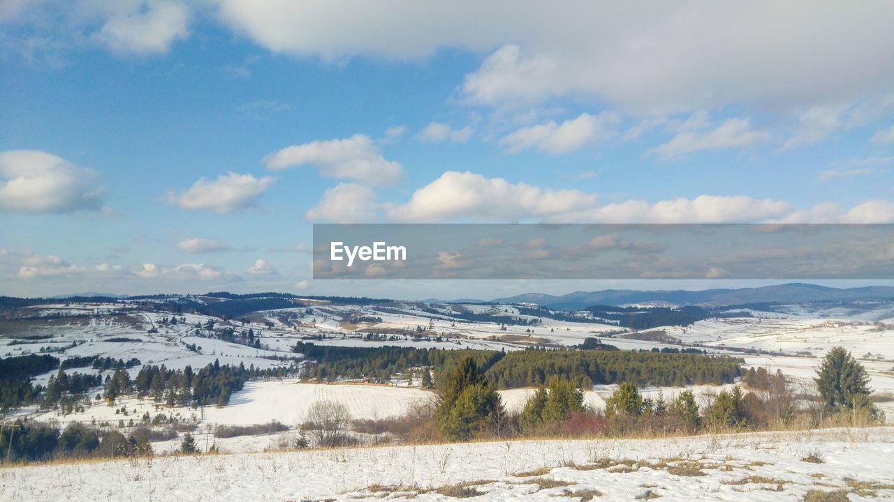 Snowcapped plateau and scattered clouds