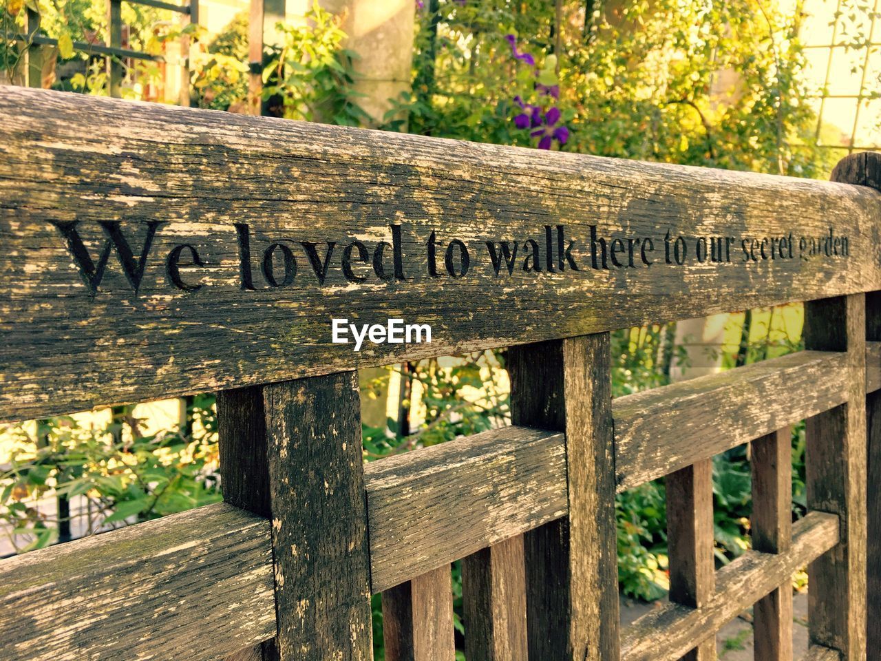 Close-up of text on wooden fence at public park