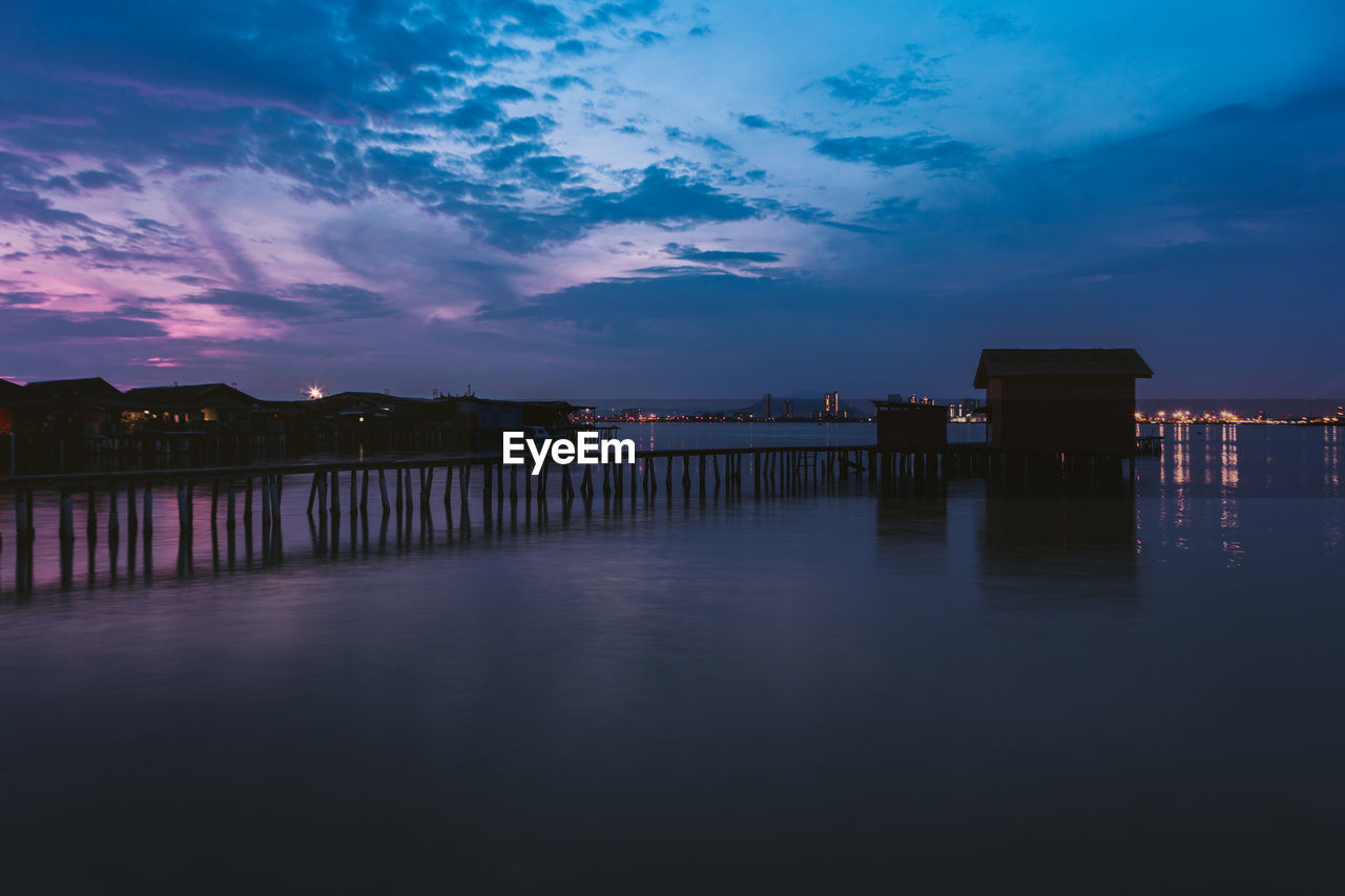 Scenic view of lake against sky at dusk