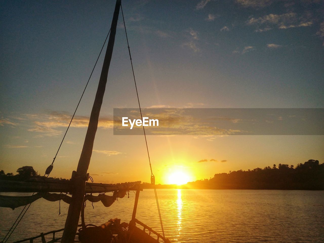 Scenic view of river against sky during sunset