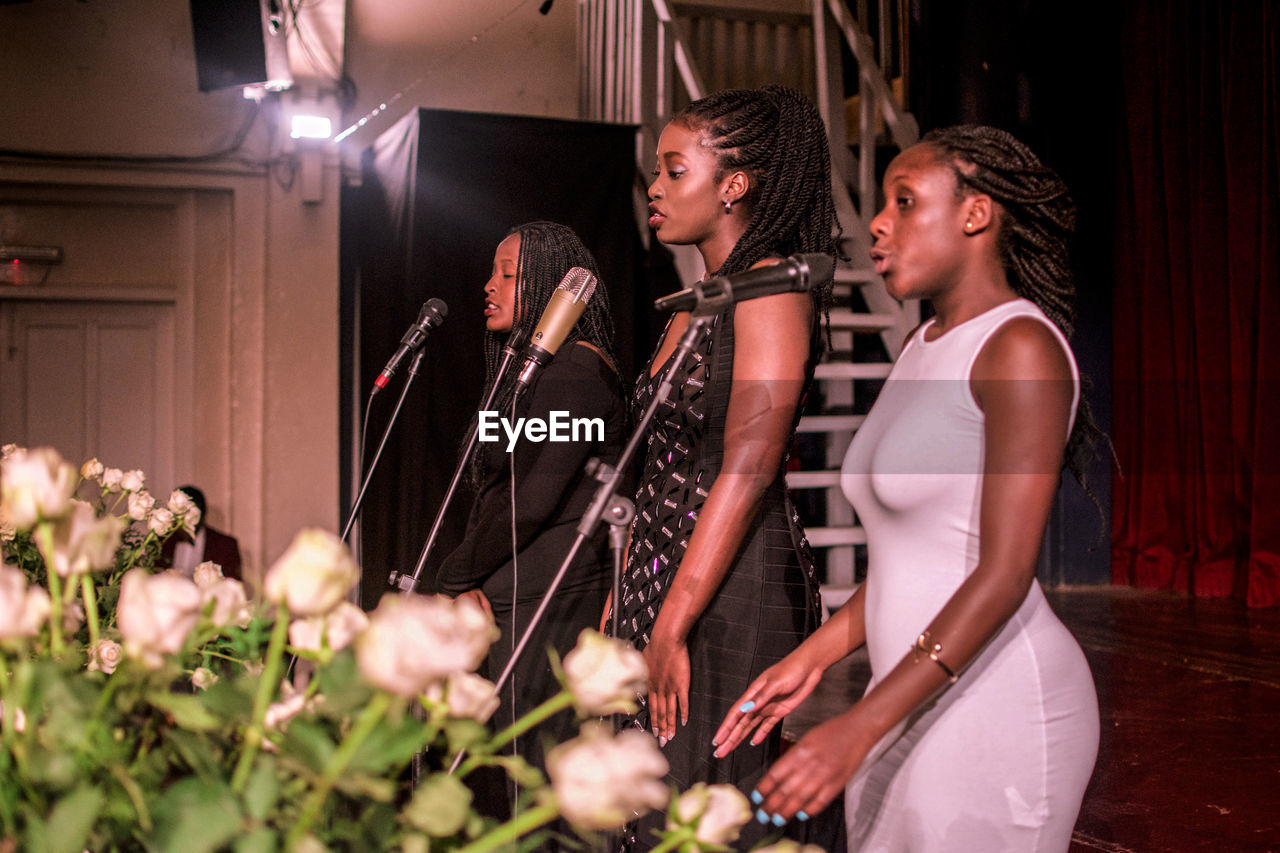 Choir singing on microphones at church