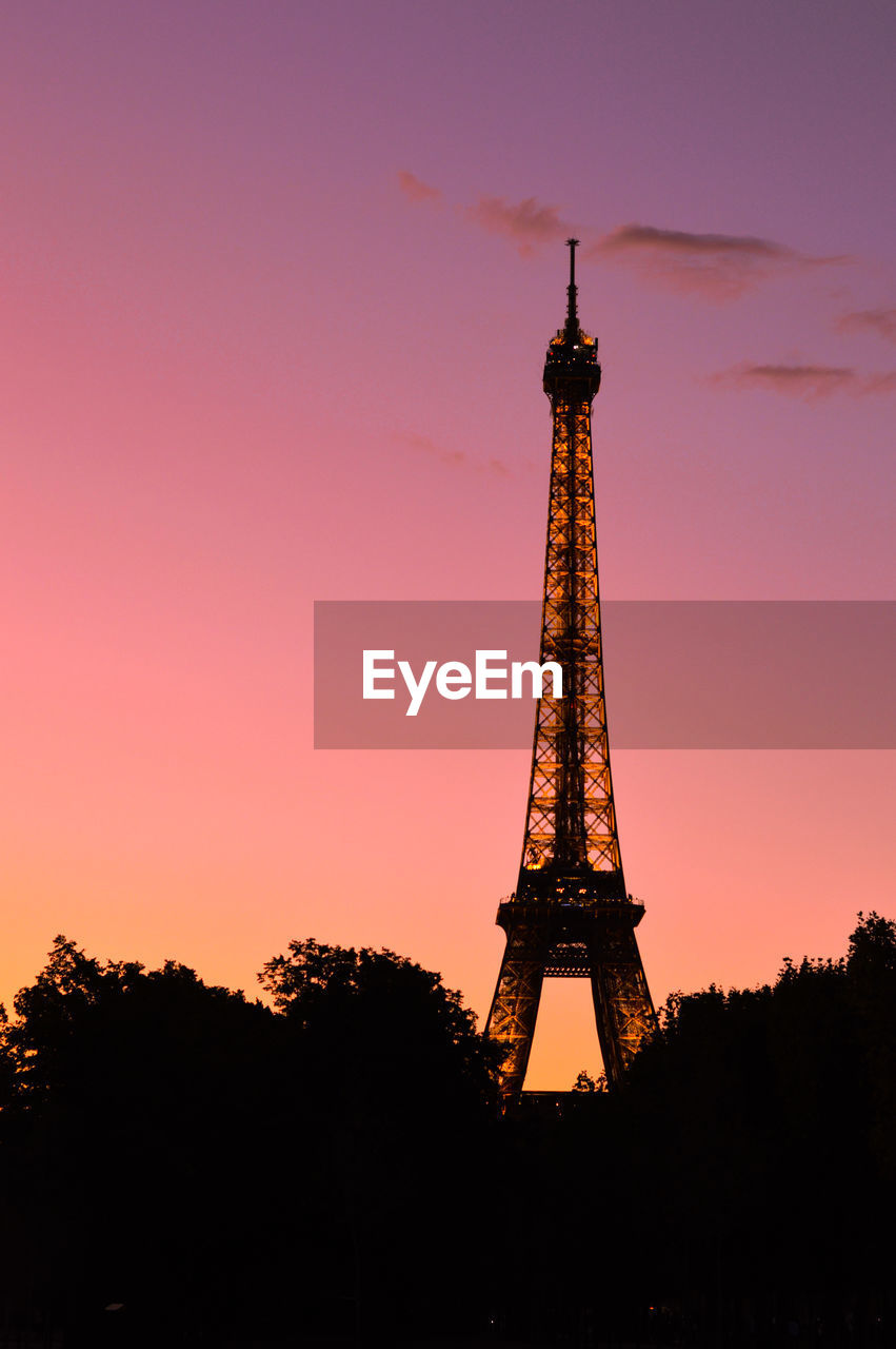 Low angle view of tower against sky during sunset