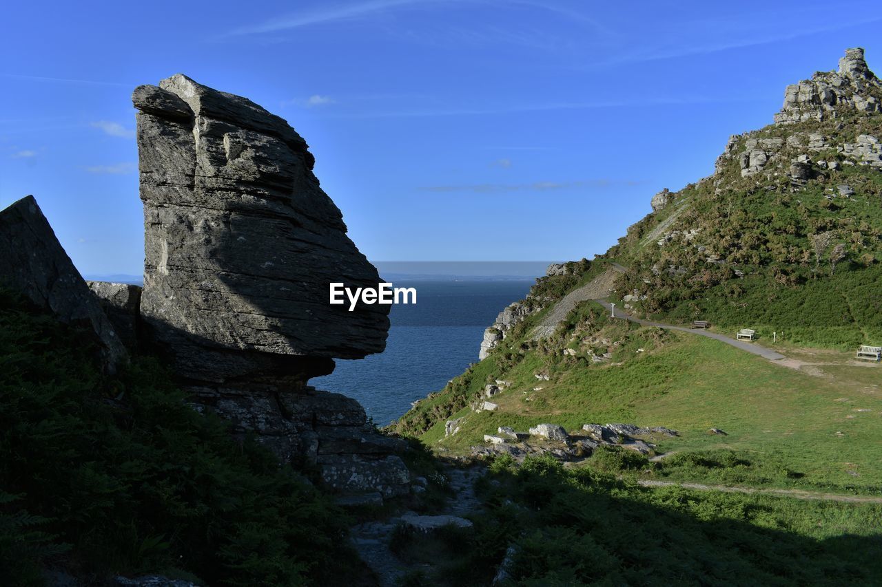 Rock formations by sea against sky