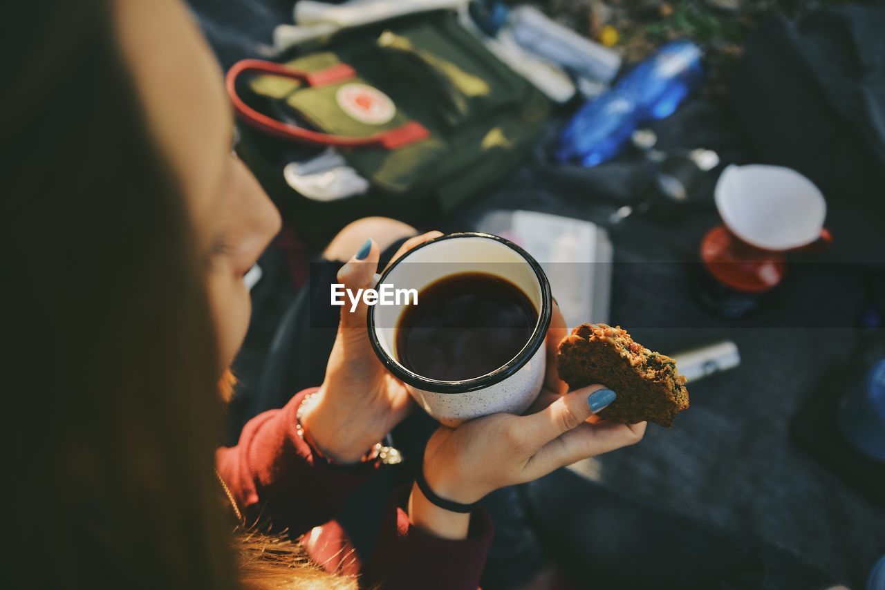 High angle view of woman holding coffee cup