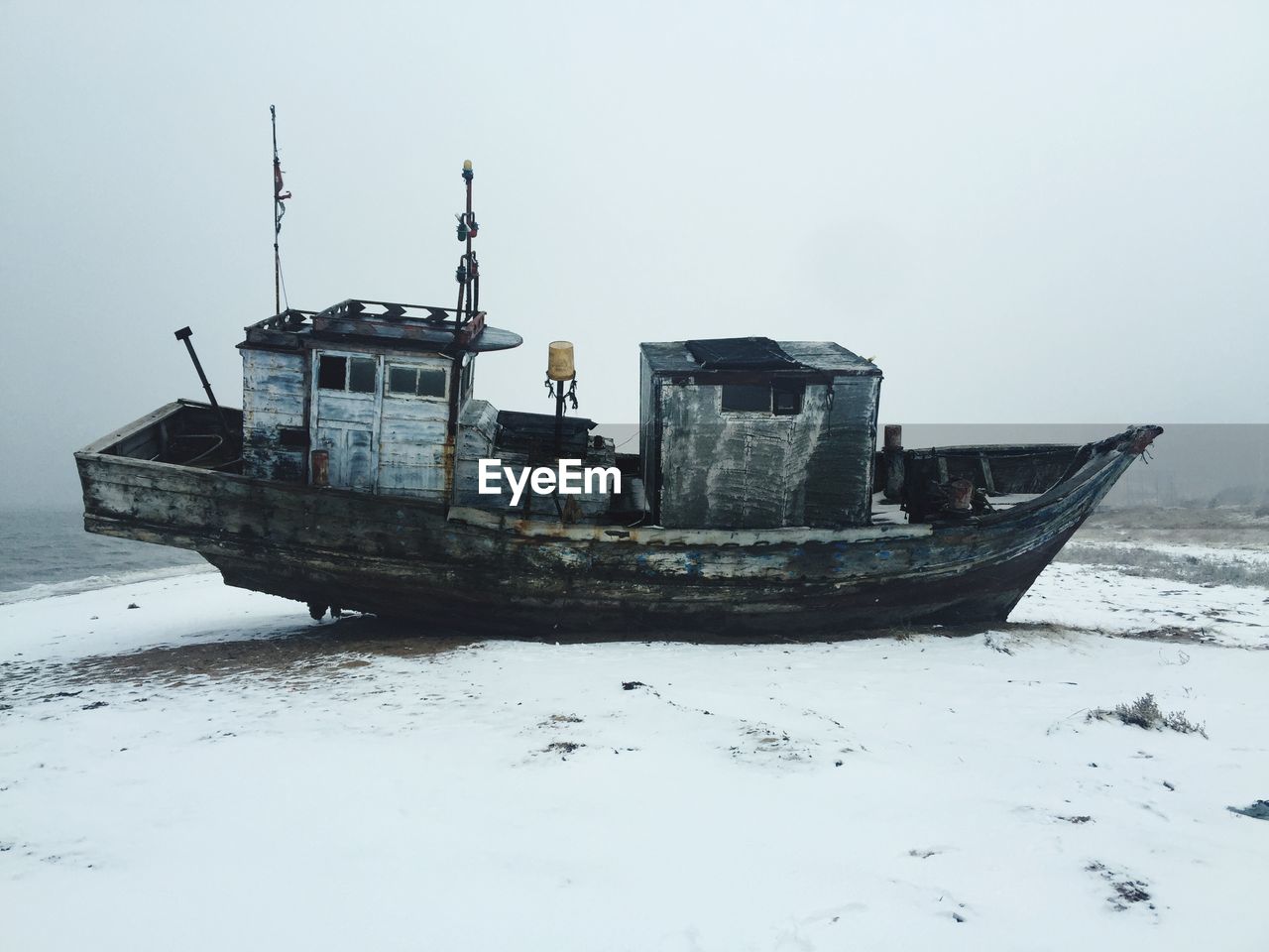 Side view of abandoned boat on the beach