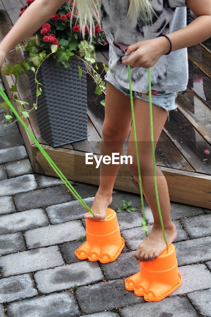 Low section of girl playing in back yard