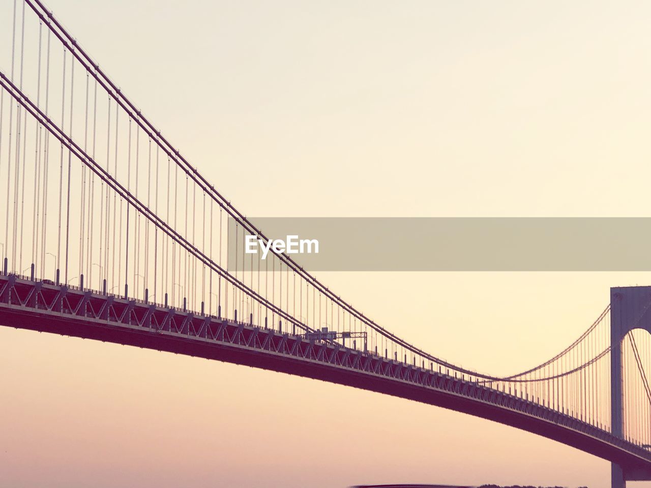 LOW ANGLE VIEW OF BRIDGE AGAINST SKY DURING SUNSET