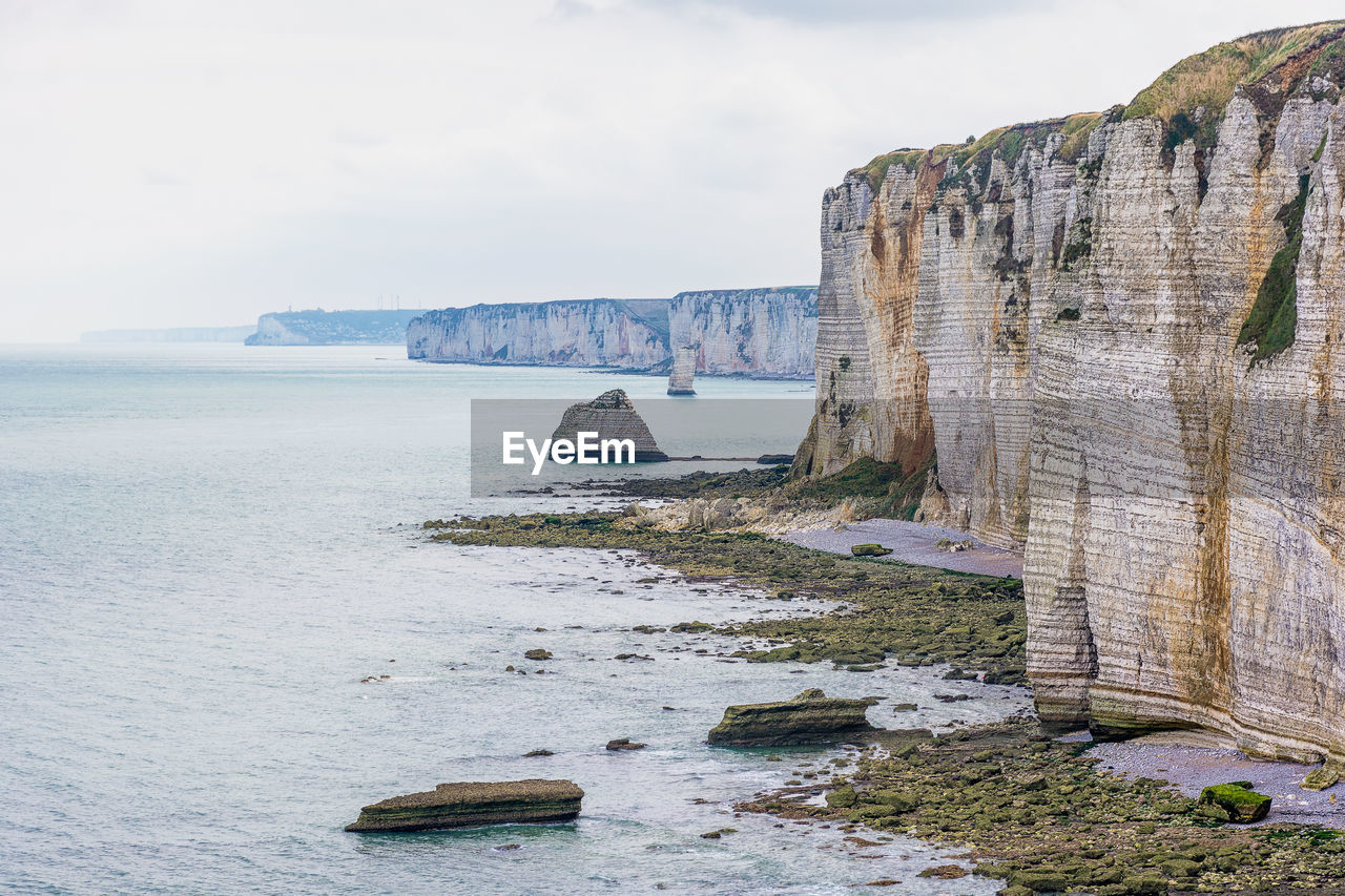 Scenic view of the white cliffs coastline at etretat in normandy, france